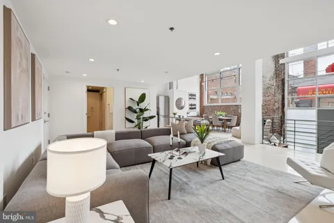 a living room with furniture and a table