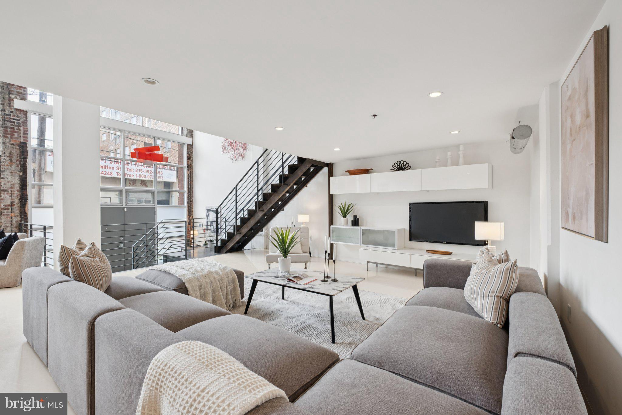 1234 Hamilton Street, Unit 102 Philadelphia, PA 19123 - Photo 5 of 25 a living room with furniture and a flat screen tv