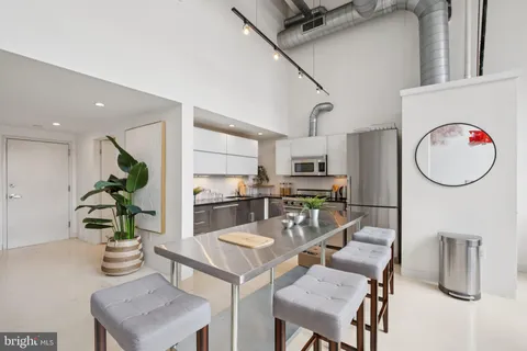 a kitchen with a table and chairs in it