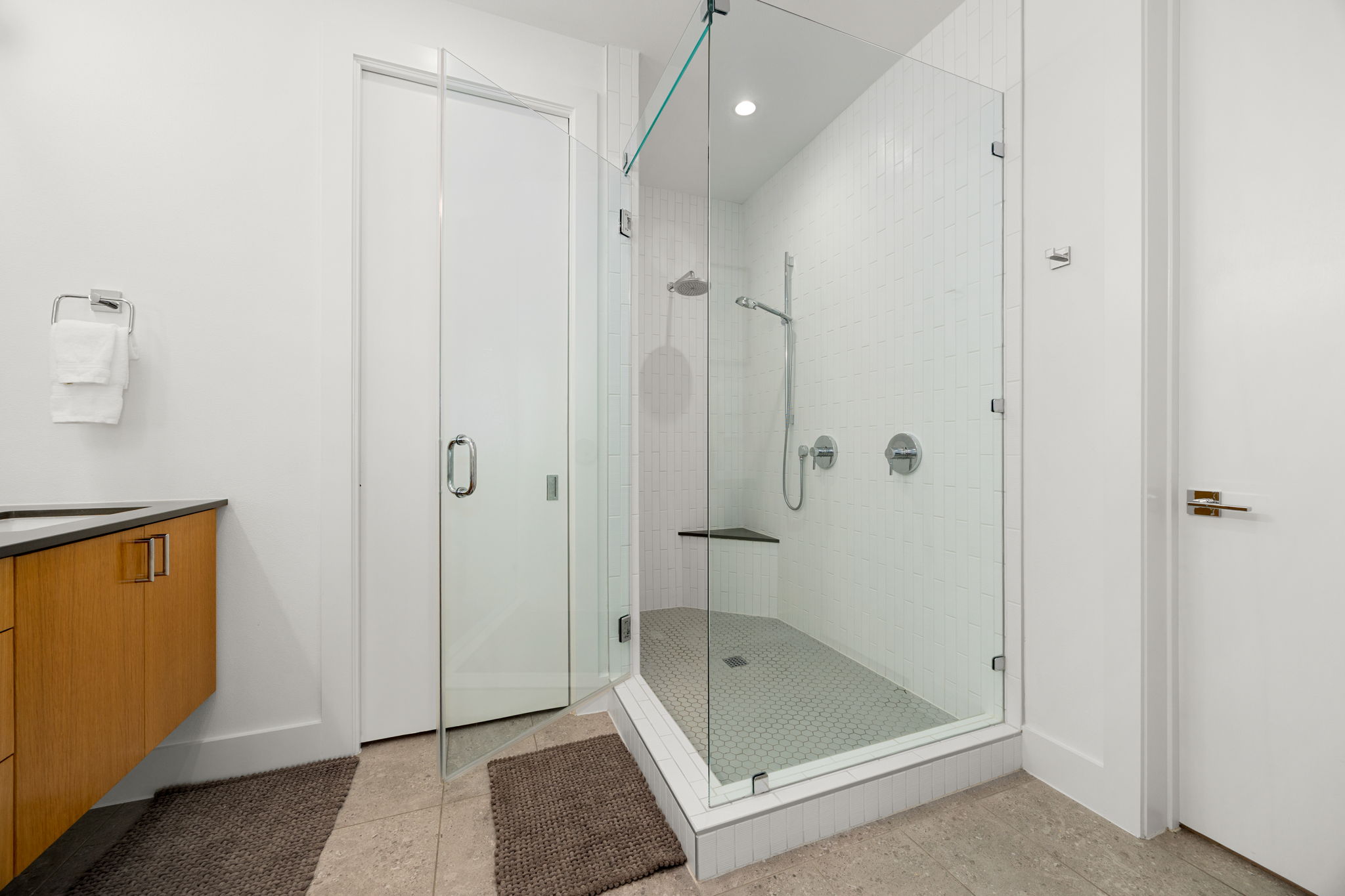 2524 Doc Reeves Street Austin, TX 78723 - Photo 18 of 36 A glass-enclosed walk-in shower anchors this modern bathroom with clean architectural lines.