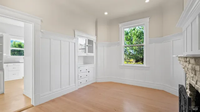 an empty room with windows and closet