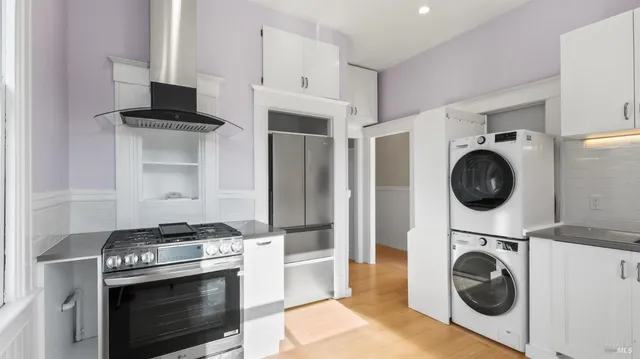 a view of kitchen with sink stove and refrigerator