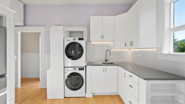 a utility room with sink dryer and washer