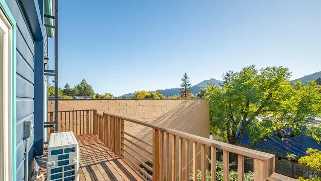 a view of balcony with wooden floor and fence