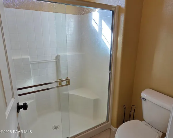a bathroom with a shower and toilet