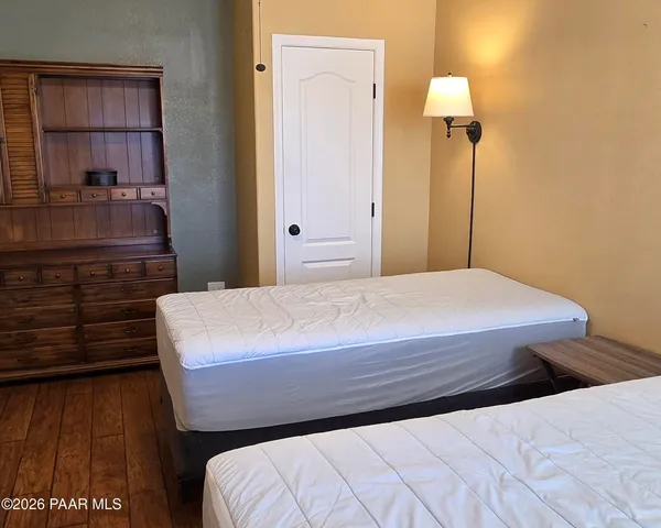 a bedroom with a bed and a night stand