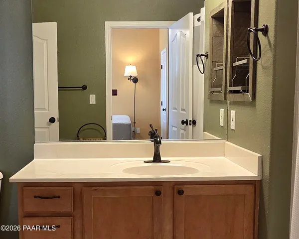 a bathroom with a sink and a mirror