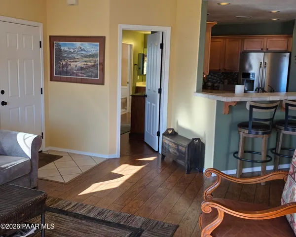 a living room with furniture and a lamp