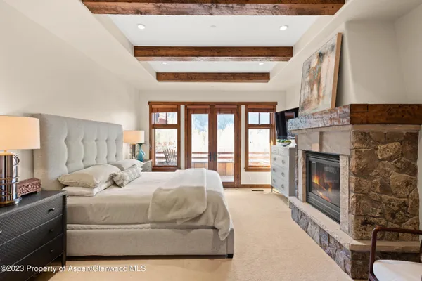 a large white bed with a fireplace in it