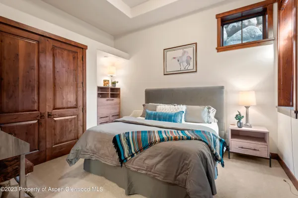 a bedroom with a bed and a night stand