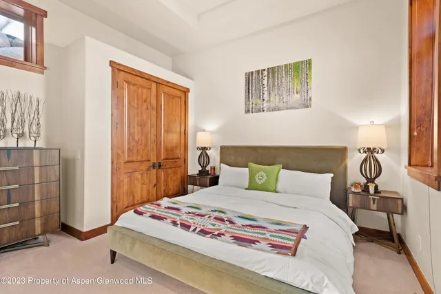 a bedroom with a bed and a mirror