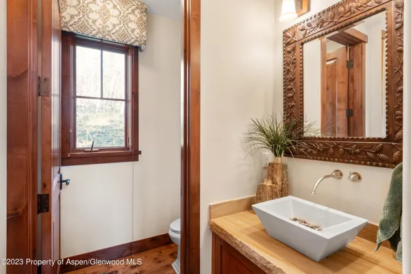 a bathroom with a sink a toilet and a window