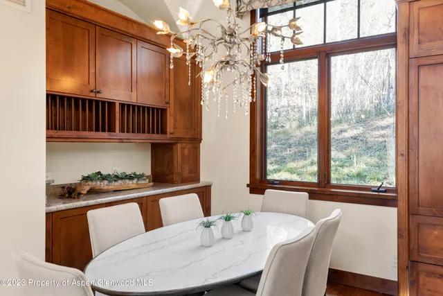 a view of a dining room with furniture window and outside view