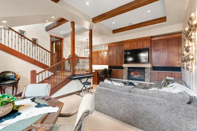 a livingroom with furniture a flat screen tv and a window