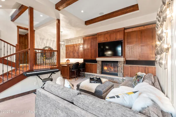a living room with fireplace furniture and a flat screen tv