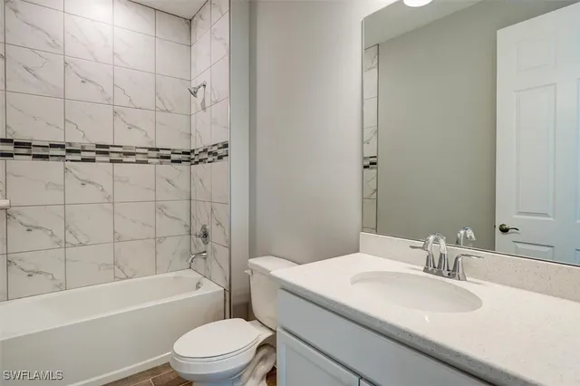 a bathroom with a sink toilet vanity and shower