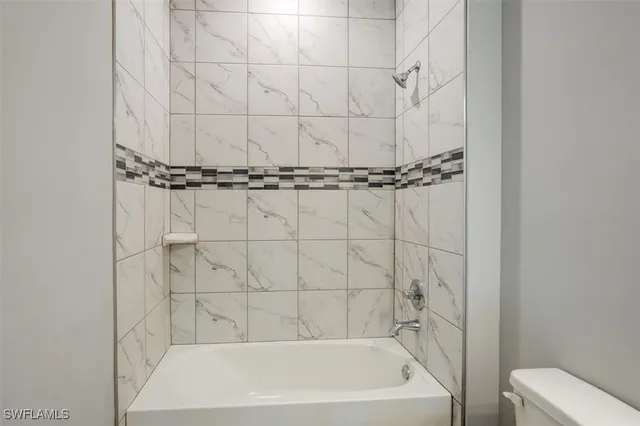 a bath tub sitting next to a white sink