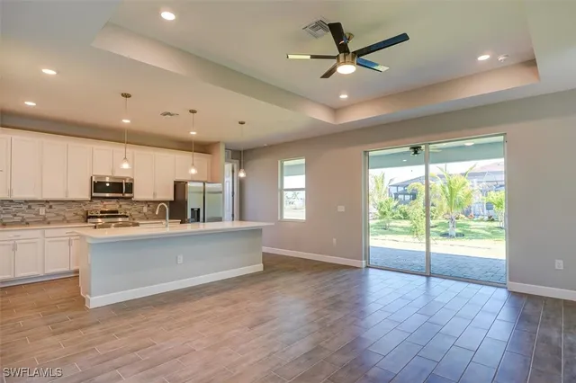 a view of kitchen with sink and microwave
