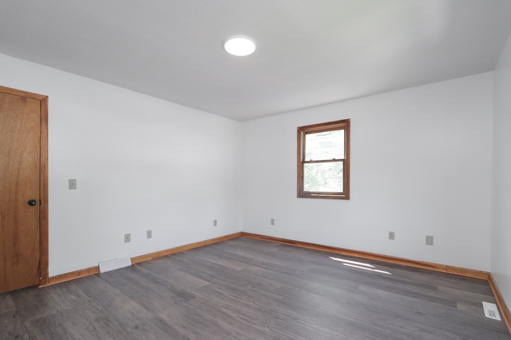 3-5 Angelo Street Springfield, MA 01119 - Photo 16 of 33 an empty room with wooden floor and windows