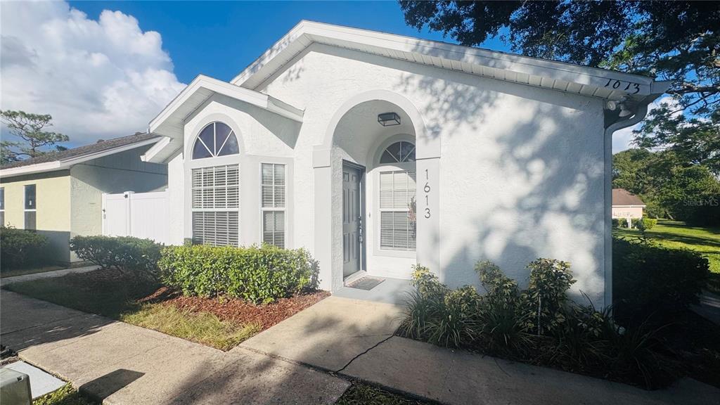 a front view of a house with garden