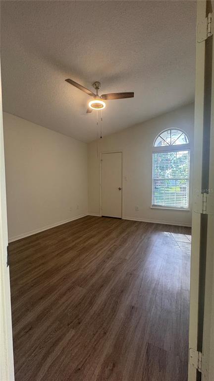 1613 Winter Green Boulevard Winter Park, FL 32792 - Photo 13 of 22 an empty room with wooden floor and windows