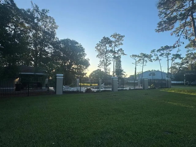 a backyard of a house with table and chairs