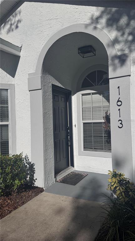1613 Winter Green Boulevard Winter Park, FL 32792 - Photo 4 of 22 a front view of a house with a yard
