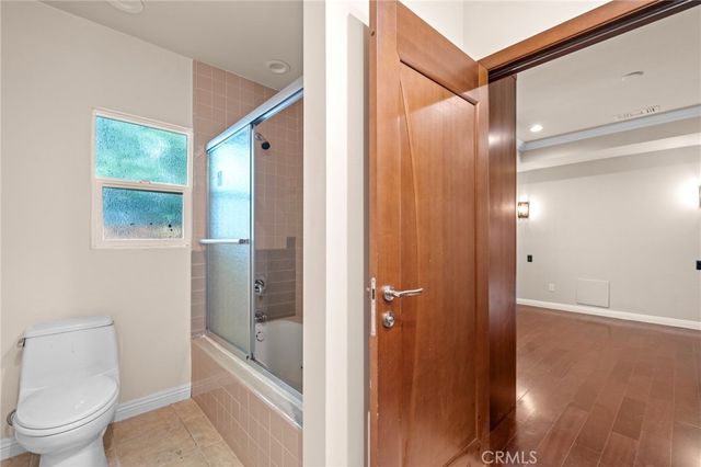 a bathroom with a toilet a sink and shower