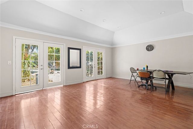 a view of a work space with wooden floor and a floor to ceiling window