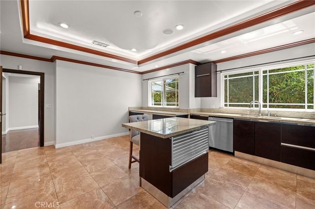 a kitchen with stainless steel appliances granite countertop a sink and a stove
