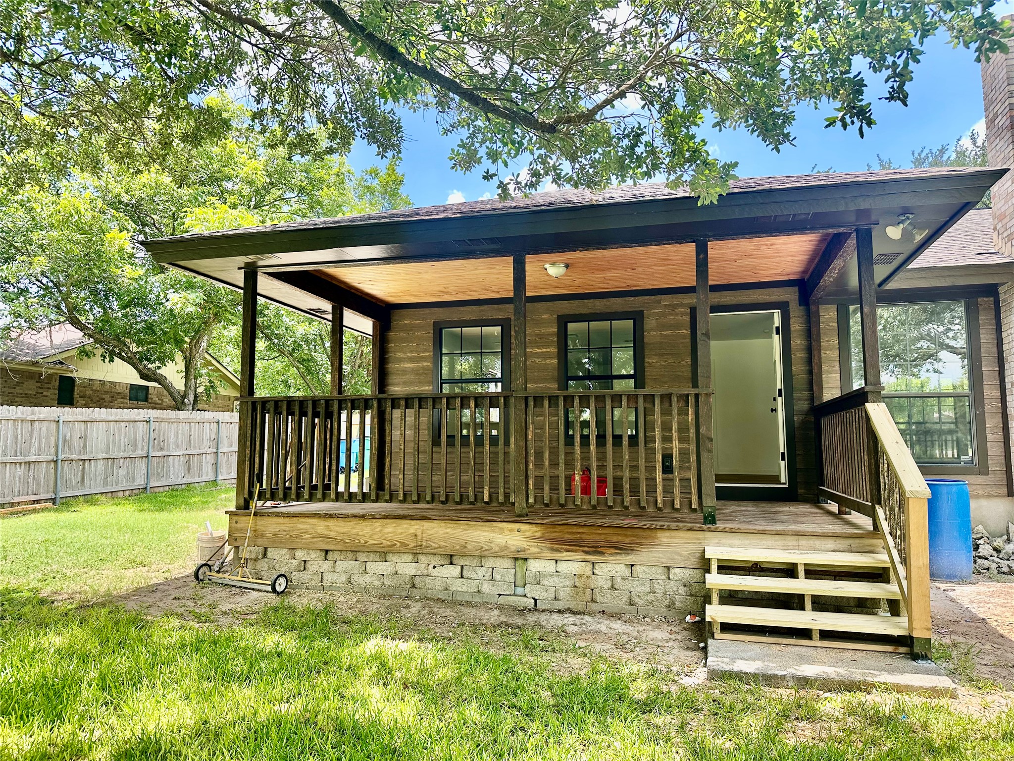 1612 Buttercup Road Pflugerville, TX 78660 - Photo 16 of 16 A quaint covered back porch invites peaceful outdoor relaxation, complementing the home's rustic charm.