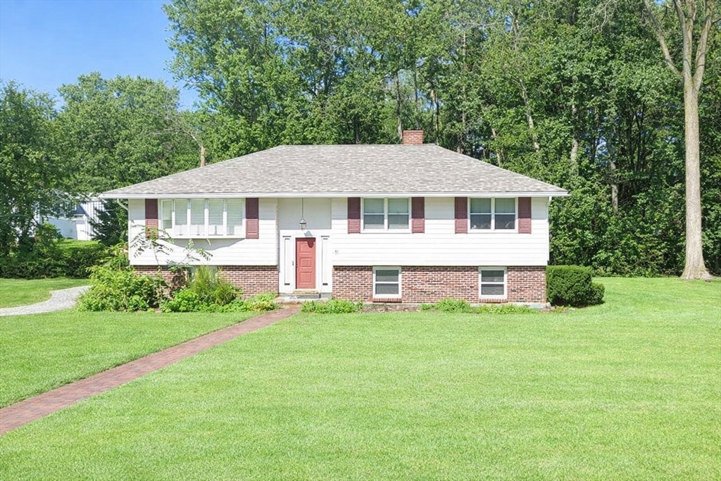 a big house with tall trees in the background