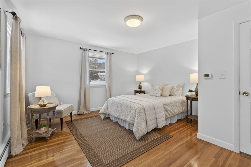 11 Rennie Drive Andover, MA 01810 - Photo 16 of 35 a bedroom with a bed and wooden floor
