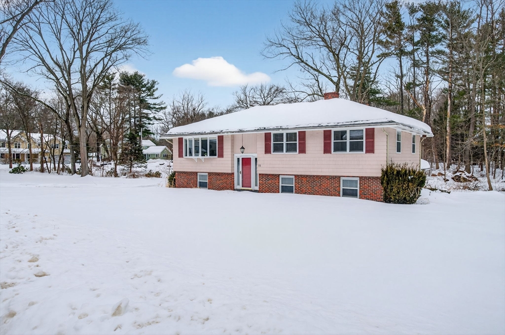 11 Rennie Drive Andover, MA 01810 - Photo 2 of 35 a front view of a house with a yard covered with snow