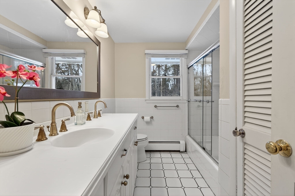 11 Rennie Drive Andover, MA 01810 - Photo 22 of 35 a bathroom with a sink a vanity and a mirror