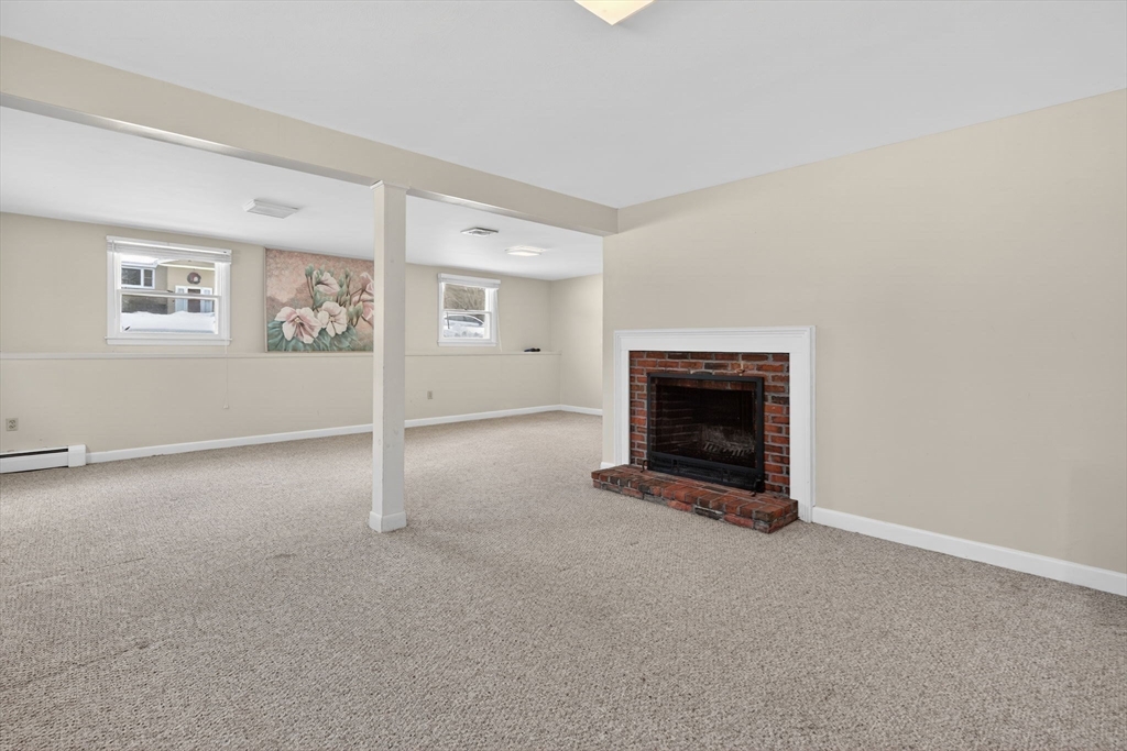 11 Rennie Drive Andover, MA 01810 - Photo 23 of 35 a view of a livingroom with an empty space and a fireplace