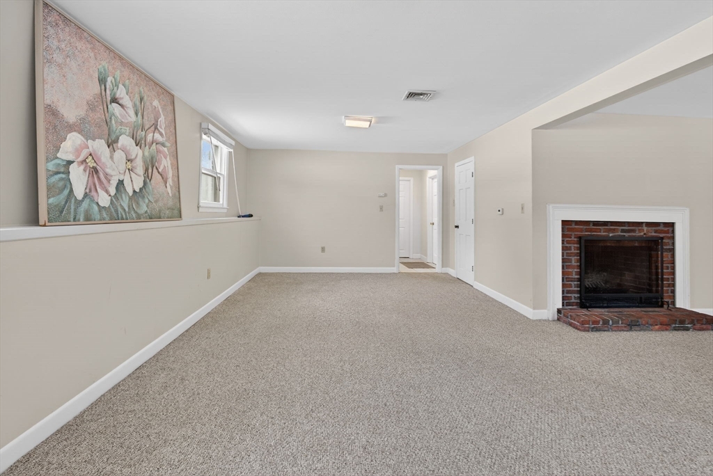 11 Rennie Drive Andover, MA 01810 - Photo 25 of 35 a view of an empty room with a fireplace and a window