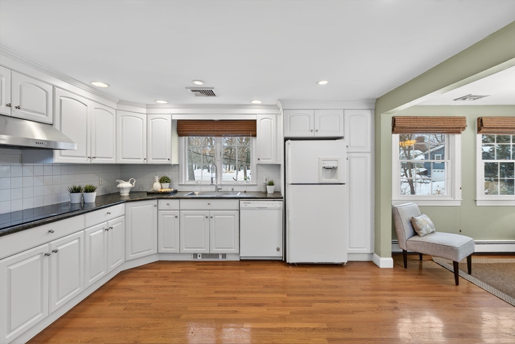 11 Rennie Drive Andover, MA 01810 - Photo 7 of 35 a kitchen with granite countertop white cabinets and white appliances