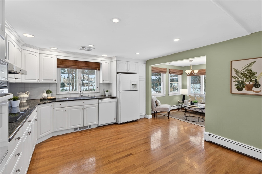 11 Rennie Drive Andover, MA 01810 - Photo 9 of 35 a kitchen with stainless steel appliances a stove a sink a refrigerator white cabinets with wooden floor