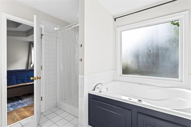 a view of a hallway with wooden floor and closet