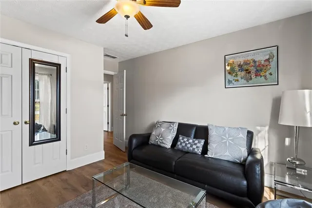 a kitchen with stainless steel appliances granite countertop a stove top oven a sink dishwasher and cabinets with wooden floor