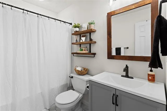 a kitchen with granite countertop cabinets stainless steel appliances and wooden floor