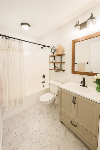 a kitchen with a refrigerator and a stove top oven