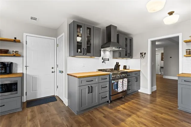 a dining room with furniture a chandelier and wooden floor
