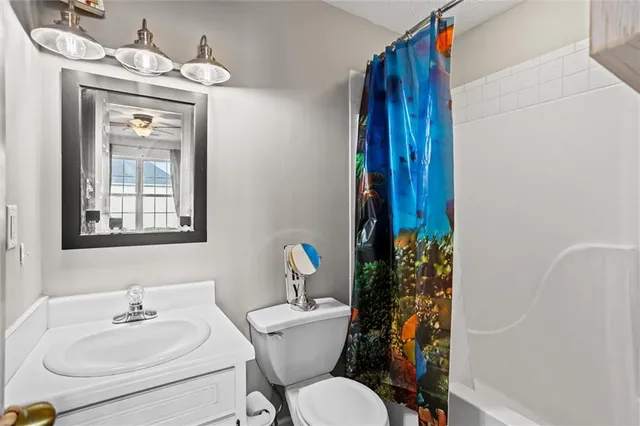 a kitchen with white cabinets a sink a stove a refrigerator and white cabinets