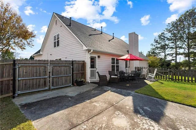 a view of a house with a swimming pool and sitting area