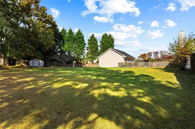 a view of hallway with window and wooden floor