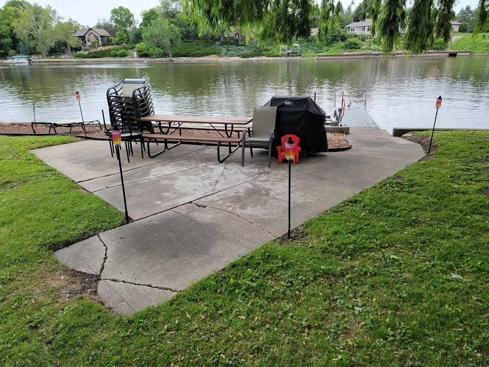 5065 Browns Beach Road Rockford, IL 61103 - Photo 4 of 13 a lake view with a bench next to a yard