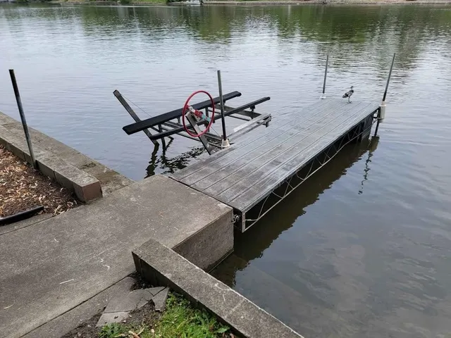 a view of a lake with chairs