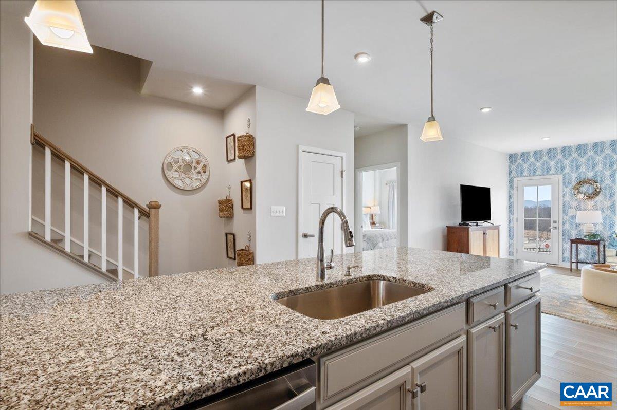 832 Swede Street Charlottesville, VA 22901 - Photo 11 of 57 a kitchen with stainless steel appliances granite countertop a sink a oven a counter space and living room view